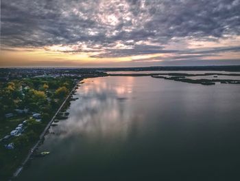 Scenic view of river against sky during sunset