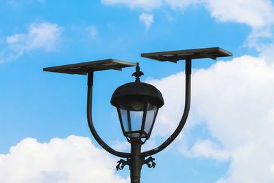 Low angle view of street light against cloudy sky