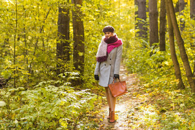 Woman standing in a forest