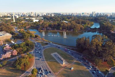 High angle view of city by river against sky