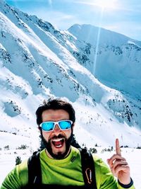 Young man using smart phone in snow