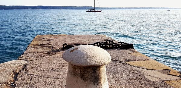 Sailboat in sea against sky