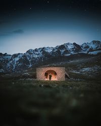 Man on mountain against sky at night