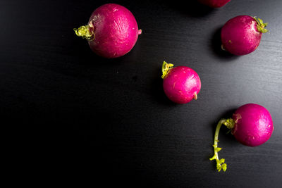 Close-up of apples on table against black background