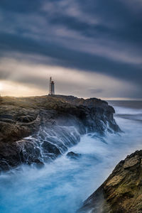 Scenic view of sea and rocks against sky