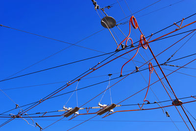 Low angle view of cables against clear blue sky