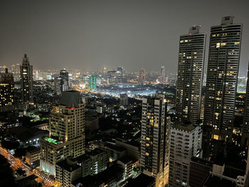 High angle view of illuminated buildings in city at night