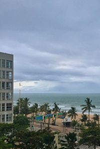 Scenic view of beach and buildings against sky