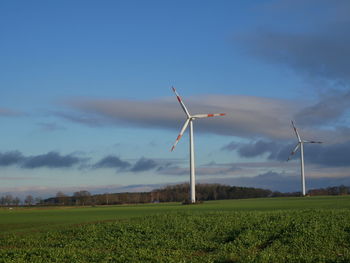 Windmill on field against sky