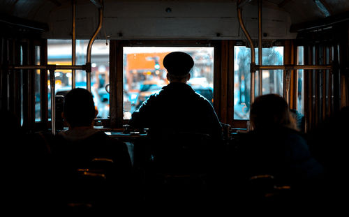 Rear view of silhouette people sitting in restaurant