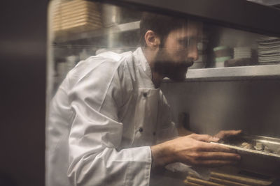 Side view of man working at home