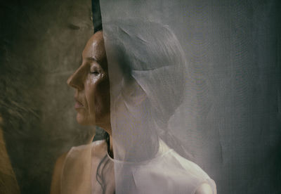 Woman behind white organza v