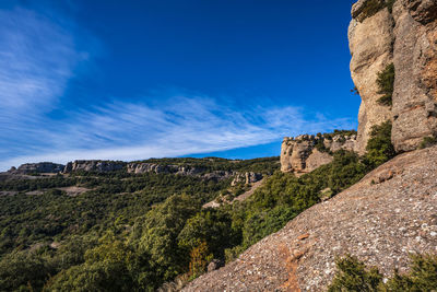 Scenic view of mountains against blue sky