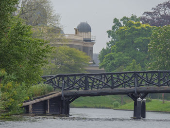 Bridge over river against buildings