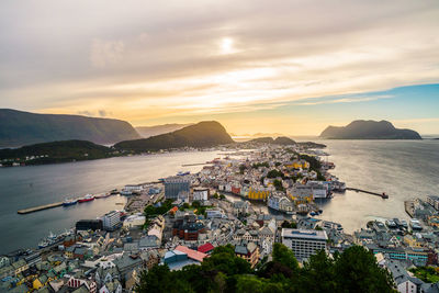 High angle view of city by sea against sky