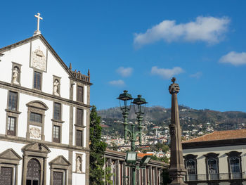 Low angle view of buildings against sky in city