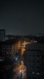 High angle view of illuminated buildings against sky at night