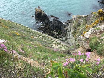 High angle view of cliff by sea against sky