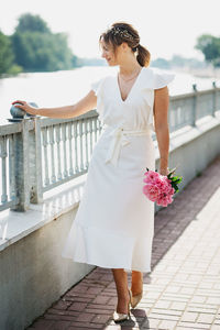 Woman standing on white wall