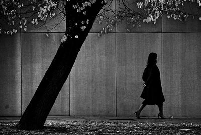 Full length of woman standing on footpath