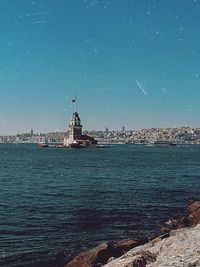 View of sea against buildings in city