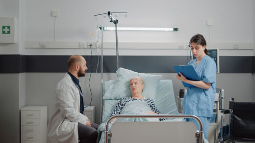 Doctor and nurse examining patient in clinic