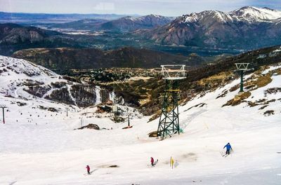 Tourists on snow covered mountain