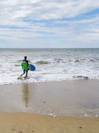 Man on beach against sky