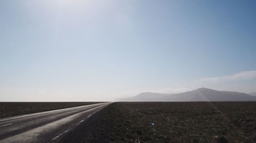 Road amidst landscape against clear sky