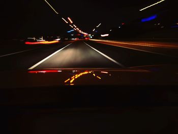 Light trails on road in city at night