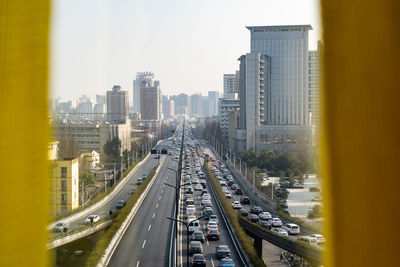 High angle view of city street and buildings against sky