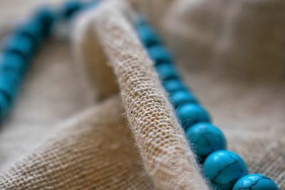 Turquoise necklace on cream colored fabric