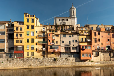 Eflections in the water to the colorful buildings and historic charm, girona in catalunya, spain, 