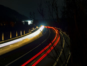 High angle view of light trails on road at night