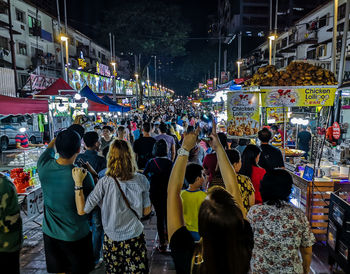 Group of people on street market at night