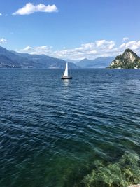 Sailboat sailing on sea against sky