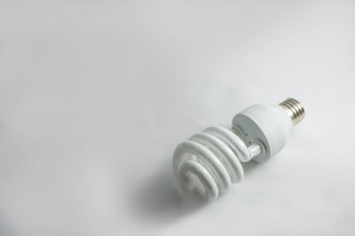 Close-up of light bulb against white background