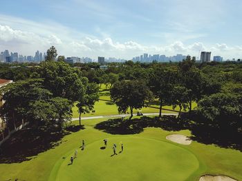 High angle view of people on lawn against trees