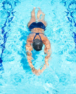 High angle view of woman swimming in pool