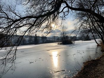 Frozen lake against sky during winter