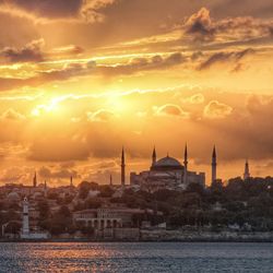 Hagia sophia in city against cloudy sky during sunset