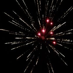 Low angle view of firework display at night