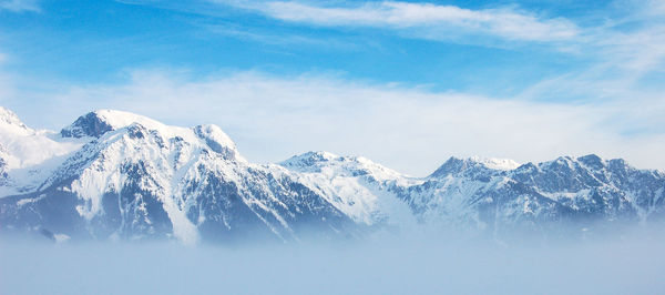 Scenic view of snowcapped mountains against sky