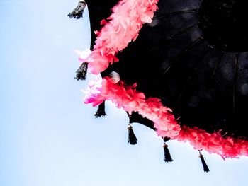Low angle view of clothes hanging against sky