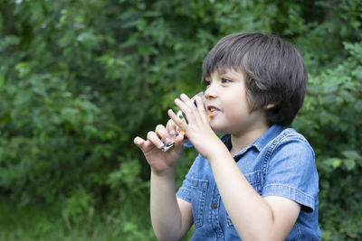 Smiling boy sitting outdoors