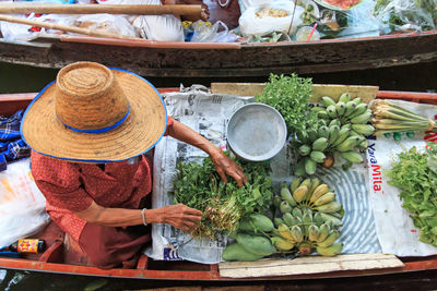 High angle view of woman selling vegetables in boat