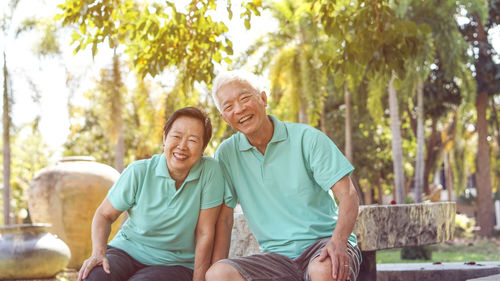 Portrait of smiling couple sitting in park