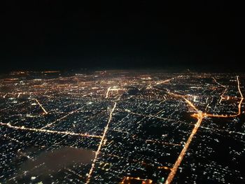 High angle view of illuminated buildings in city at night