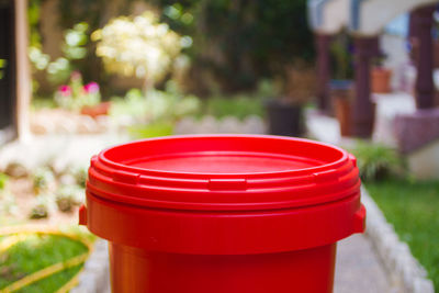 Close-up of red garbage bin in yard
