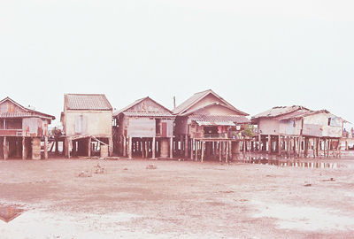 Houses on beach against clear sky